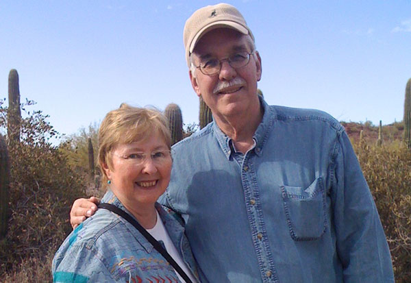 Patricia Best and Thomas Ray stand together in the desert for a candid vacation photo.